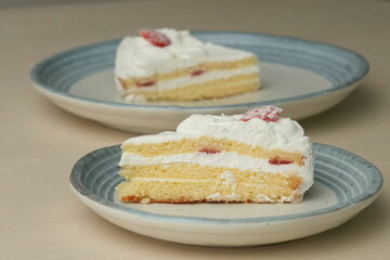Japanese strawberry shortcake on each stylish large and small plate on a wooden table