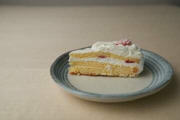 Japanese strawberry shortcake on each stylish large and small plate on a wooden table