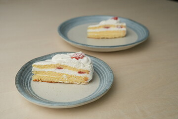 Japanese strawberry shortcake on each stylish large and small plate on a wooden table