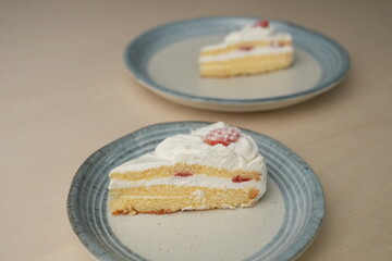 Japanese strawberry shortcake on each stylish large and small plate on a wooden table