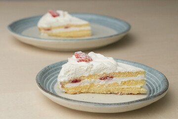 Japanese strawberry shortcake on each stylish large and small plate on a wooden table