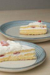 Japanese strawberry shortcake on each stylish large and small plate on a wooden table