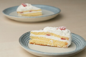 Japanese strawberry shortcake on each stylish large and small plate on a wooden table