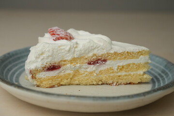 Japanese strawberry shortcake on a stylish large plate on a wooden table
