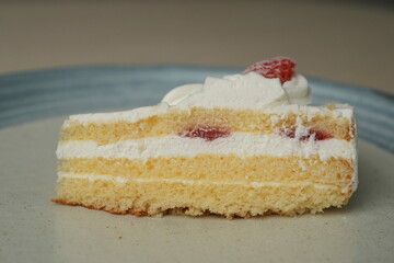 Japanese strawberry shortcake on a stylish large plate on a wooden table