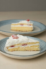 Japanese strawberry shortcake on each stylish large and small plate on a wooden table