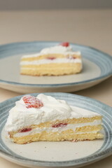 Japanese strawberry shortcake on each stylish large and small plate on a wooden table