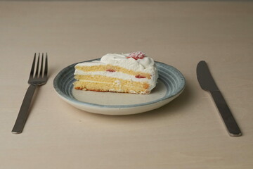 Japanese strawberry shortcake on a stylish large plate on a wooden table
