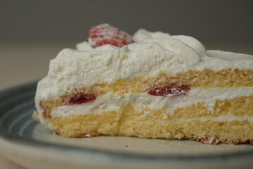 Japanese strawberry shortcake on a stylish large plate on a wooden table
