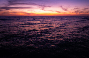 Aerial view sunset sky, Nature beautiful Light Sunset or sunrise over sea, Colorful dramatic majestic scenery Sky with Amazing clouds and waves in sunset sky purple light cloud background