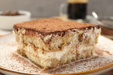 Piece of tasty tiramisu on table, closeup