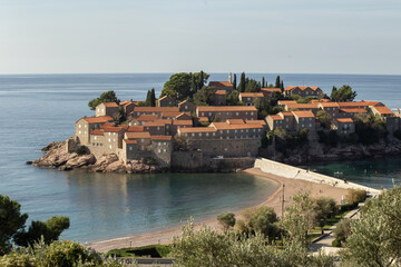 Fototapeta premium Panoramic view of island Sveti Stefan, Budva, Adriatic Mediterranean Sea, Montenegro. Summer vacation in exclusive luxury hotel complex resort at the seaside. High quality photo