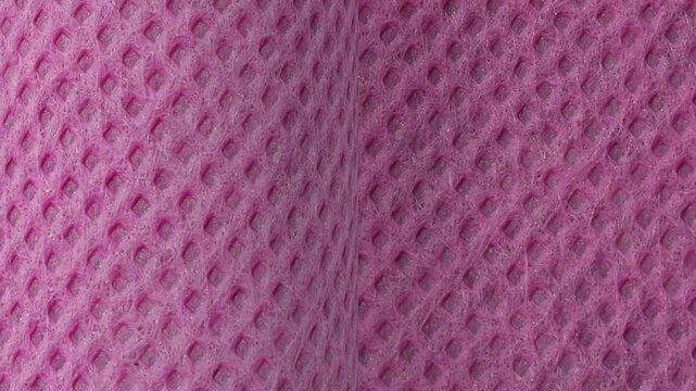 texture of the purple non-woven fabric is rough and porous. polypropylene fabric roll