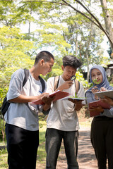 Asian Diverse Students Observing Plants In Outdoor Lesson