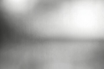 A blurry image of a silver surface with a few specks of dust