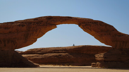Silhouette of person under beautiful Saudi Arabian rock arch
