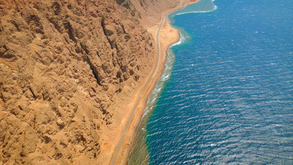 Beautiful ocean meeting Saudi Arabia shore near rocky mountains - high shot