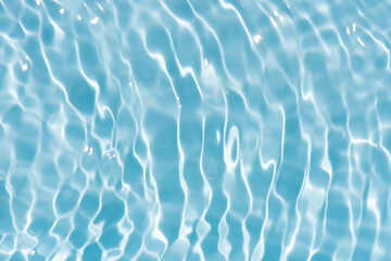 Blue water with ripples on the surface. Defocus blurred transparent blue colored clear calm water...