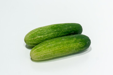 Green cucumber isolated on white background. Green cucumbers texture template arranged and harvested