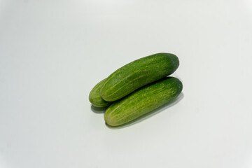 Green cucumber isolated on white background. Green cucumbers texture template arranged and harvested