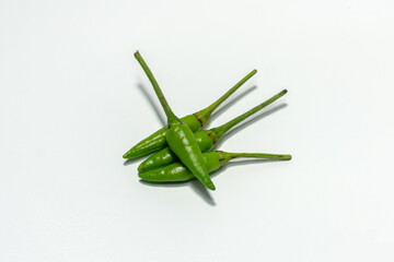 spicy green cayenne pepper isolated on white background. Chili padi, small pepper. Cabe rawit hijau...