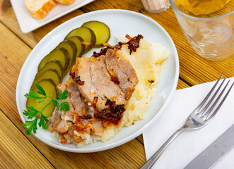 Delicious pork steak served with potatoes and pickles. Festive dinner
