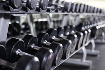 Rows of dumbbells for weight training in gym