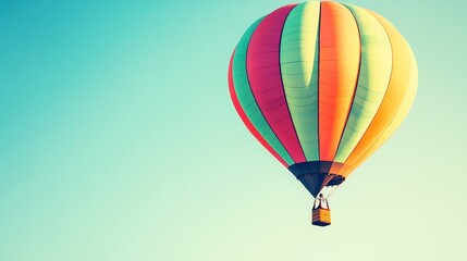 Obraz premium A colorful hot air balloon soaring against a clear blue sky.