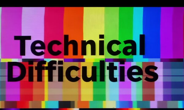 A colorful test pattern screen with various shades of RGB bars, overlaid with the words &lsquo;Technical Difficulties&rsquo; in large text