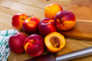 Fresh organic nectarine on wooden background, fruit vegan food