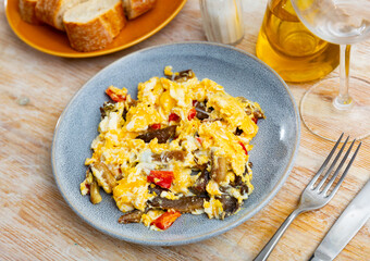 Appetizing omelet with mushrooms and bell peppers served on plate