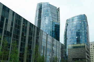 View of modern skyscrapers in city on cloudy day