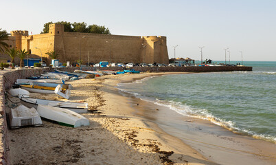 Town of Hammamet in Tunisia, Africa. View of ancient fort, coastline and fishing boats