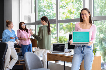 Female programmer with laptop in office