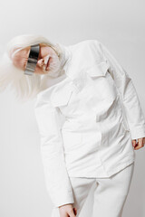 Futuristic fashion with a white outfit and unique eyewear, featuring a model with white hair...