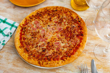 Delicious italian pizza carbonara with bacon and cheese served on plate