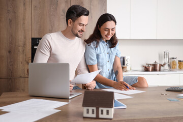 Young couple discussing something and writing down at home. Bankruptcy concept