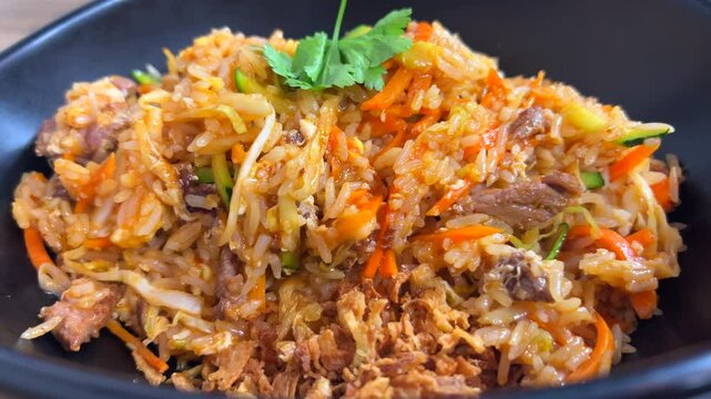 Thai fried rice with vegetables and beef, tasty Asian food, 4K shot
