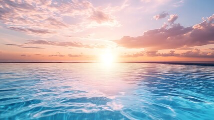 Obraz premium Peaceful sunset over the ocean with blue water reflecting sky and clouds. Tranquil and calming landscape photograph.