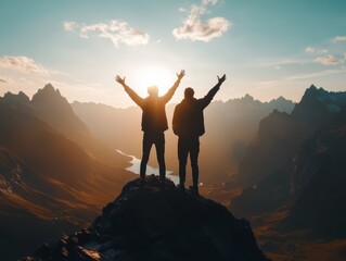 Obraz premium Two silhouetted figures celebrate atop a mountain during sunset, surrounded by scenic landscapes.