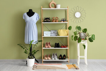 Interior of dressing room with mannequin, shelf unit and plants