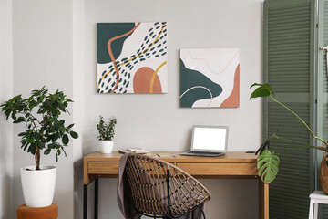 Workplace, armchair and folding screen in interior of stylish living room