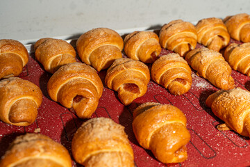 Croissants or bagels with jam on the production floor. Mini bakery, sweet pastries. High quality photo