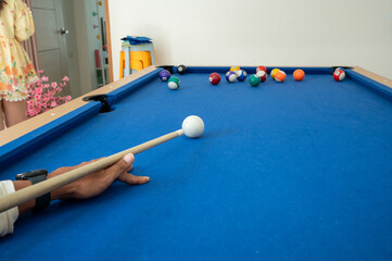A minimalist composition of a billiard ball and cue, capturing the essence of precision and focus.
