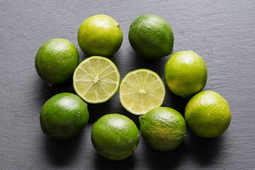 Fresh Green Limes On A Black Slate Background