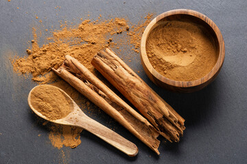 Cinnamon Sticks and Powder on Gray Slate