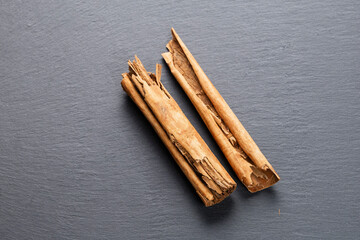 Cinnamon Sticks and Ground Spice on Slate