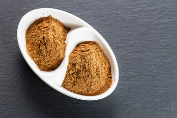 Cinnamon Sticks and Ground Spice on Slate
