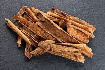 Cinnamon Sticks and Ground Spice on Slate