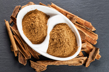 Cinnamon Sticks and Ground Spice on Slate